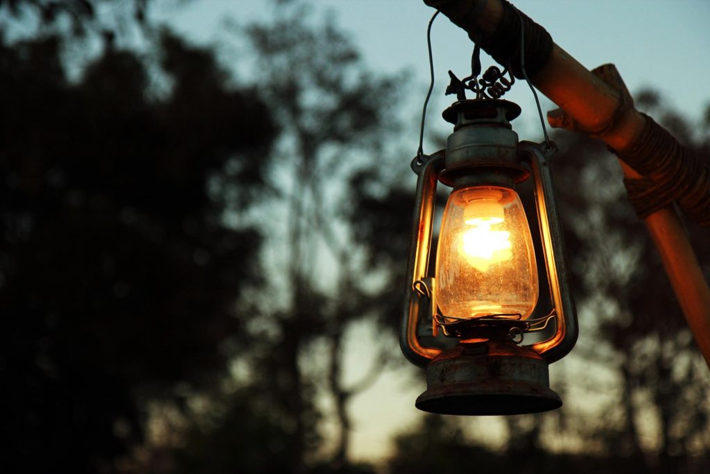 Kerosene lamp hanging from a wooden beam